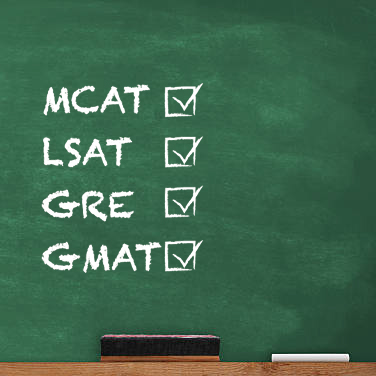 MCAT, LSAT, GRE, and GMAT written on chalkboard